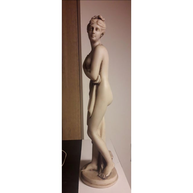 This finely crafted miniature sculpture is a faithful 19th-century reduction of Antonio Canova's iconic Venus Italica...