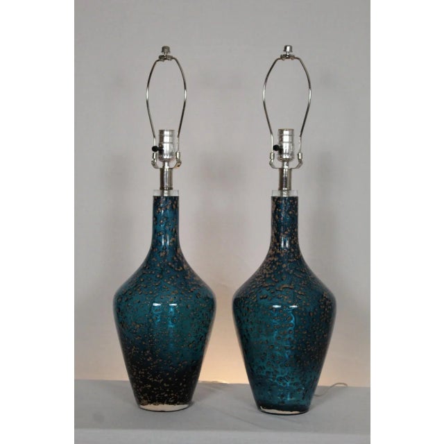 A pair of Pulguso influence Murano glass lamps.. Gracious and simple in shape. Deep teal blue. Because each piece is hand...