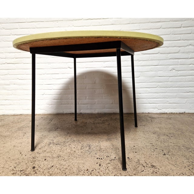 Mid-century French furniture at its Frenchest. This yellow round dining table was designed by the famous designer Pierre...