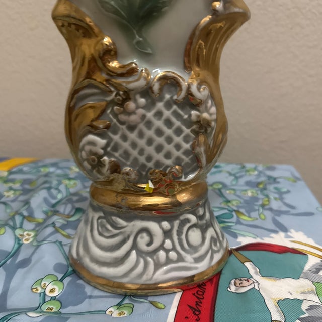 This empty collectible bottle stands approximately 15 to 17 inches tall and features an elegant, swirling Hollywood...