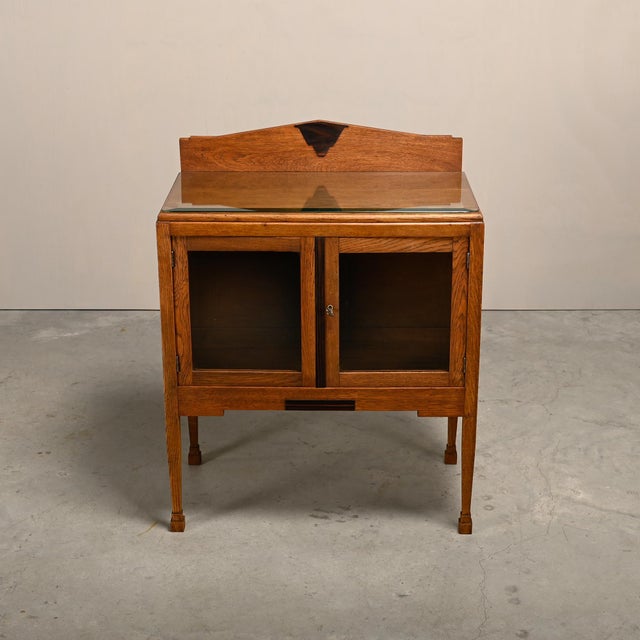 Beautiful Art Deco tea cabinet in the Amsterdam School style, a striking Dutch design from the 1930s. Solid oak frame with...