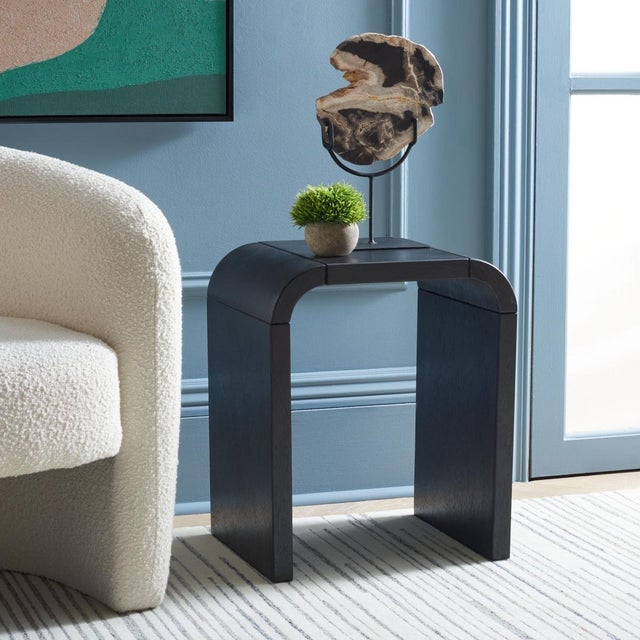 Discover the elegance of the liasonya curved accent table in black. This exquisite piece blends style and functionality to...