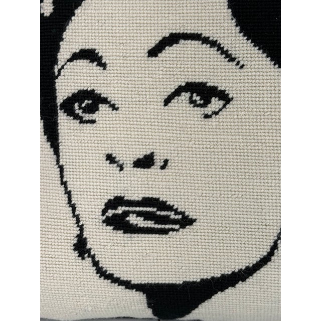 Classic Jonathan Adler “Tramp” needlepoint pillow featuring a hand-embroidered black and white portrait of Joan Crawford....