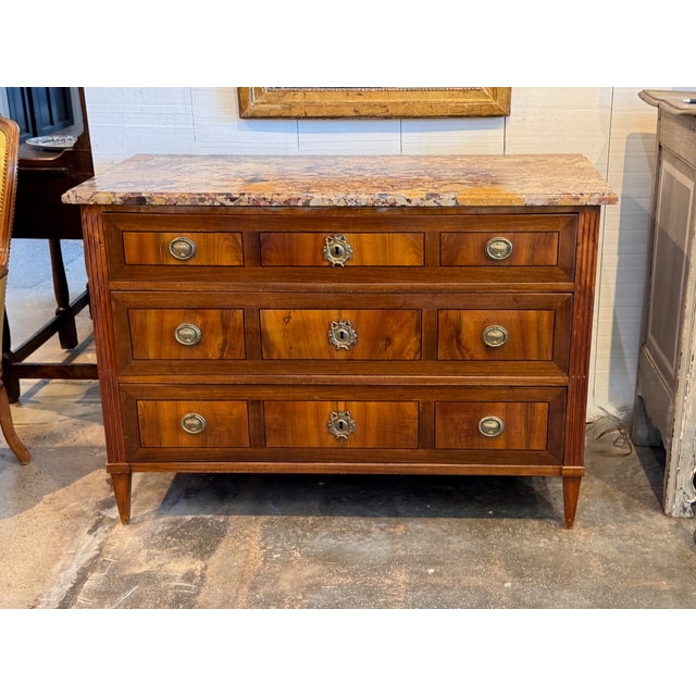 Directoire inlaid commode of three long drawers, the figured walnut fronts framed with line inlay and crossbanding, fitted...
