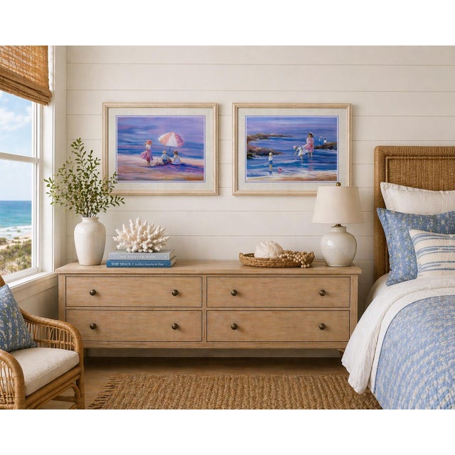 A charming pair of framed coastal lithographs by Nora DeBolt, published in 1992, featuring softly rendered beach scenes...