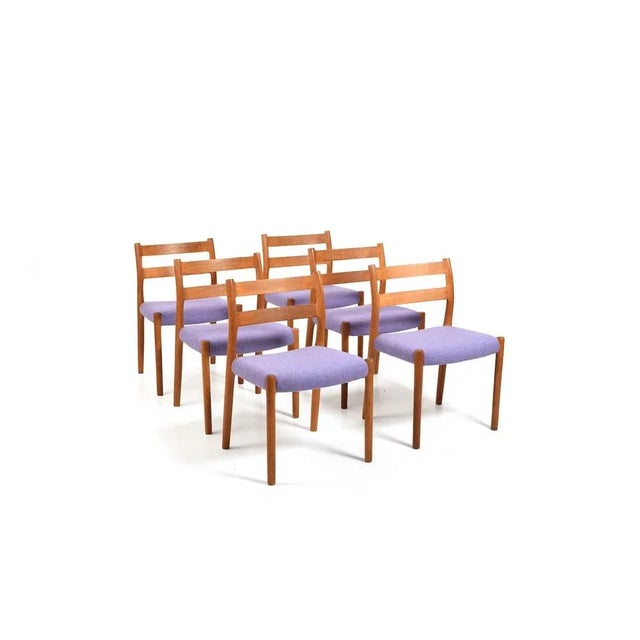 Niels O. Møller dining chairs in solid oak. New upholstered with purple Kvadrat fabric by Nanna Ditzel series. Model no....