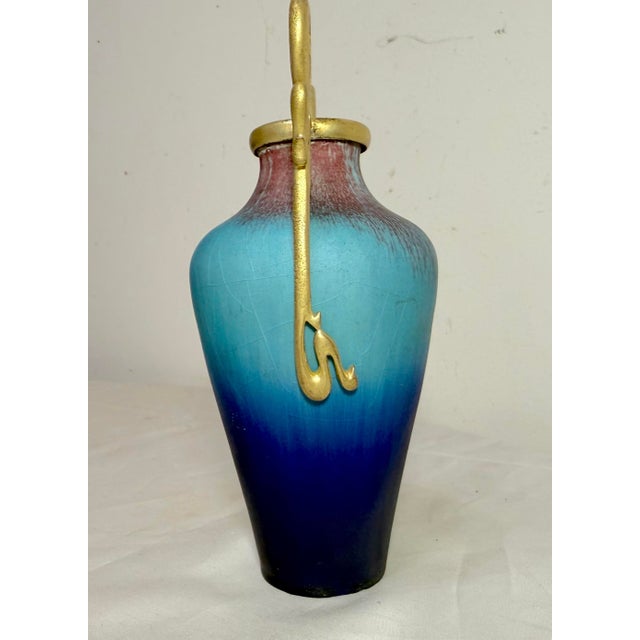 The exquisite French antique Eugene Baudin (1843-1907) bronze mounted pottery vase is a unique and beautifully crafted...