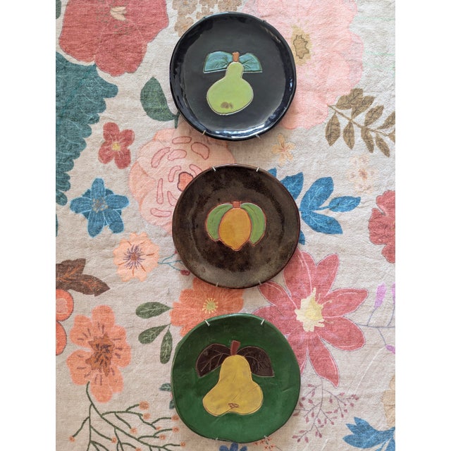A Set of 3 Vintage 90's Studio Pottery Decorative Plates featuring a different Fruit motif on each Made by R. Wood Pottery...