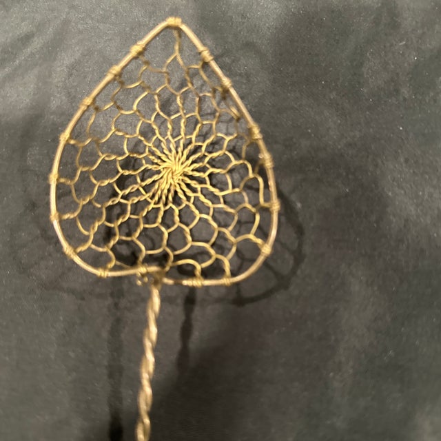 The vintage one owner handmade brass bronze twisted wire strainer with a gorgeous heart shape mash. And it’s long twisted...