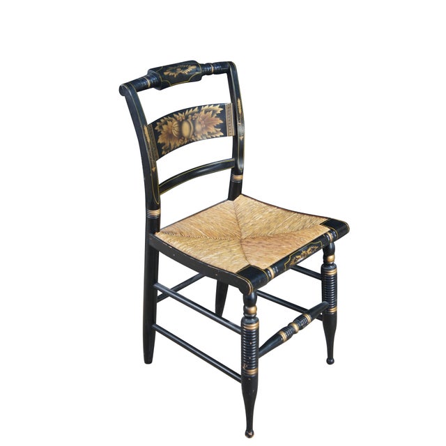 Two antique early 20th Century original L. Hitchcock Harvest Windsor dining chairs. Made with an ebonized finish, gold...