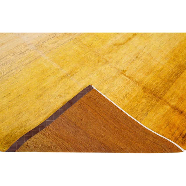 Beautiful modern Gabbeh-style hand-woven wool rug with a yellow and beige color field and gorgeous solid design. This rug...