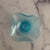 Gorgeous colors in this vintage mid-20th century art glass small bowl. Iridescent blue and quad-crimped edging.