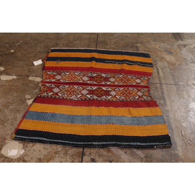 Hand knotted in wool originating from Turkey circa 1900-1910, this antique rug connotes a traditional Kurdish rug design...