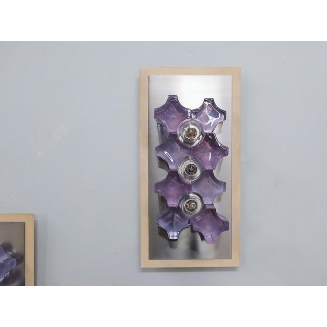 Elegant pair of wall sconces designed by poliarte in the 1970s, featuring metal panels with brushed steel inserts. The...