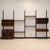 A custom mid-century modern walnut wall unit dating to approximately the 1960s. The modular system combines warm walnut...