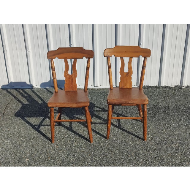 Pair of antique farm-style chairs in great condition. The tone of the wood sets these apart from the norm. All joinery is...