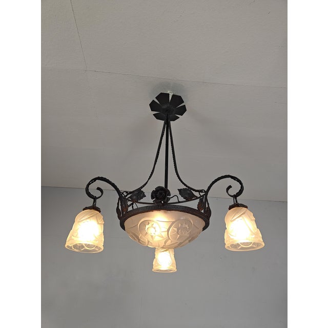 This beautiful french chandelier from the art deco/art nouveau era captivates with its elaborate design. The thick-walled...