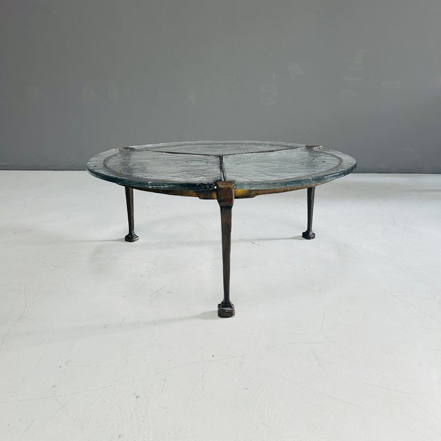 This coffee table by Lothar Klute consists of three separate glass panels that can be leveled using screws on the...