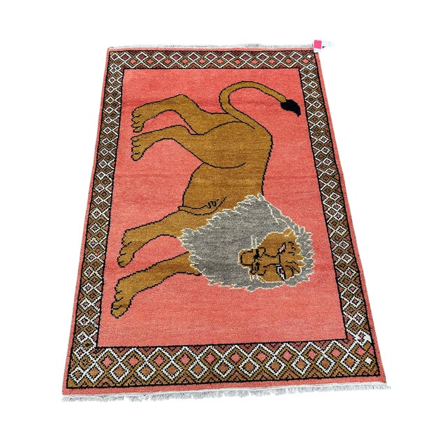A bold 1980s handmade rug featuring an oversized lion motif in a striking large-scale composition. Graphic, playful, and...