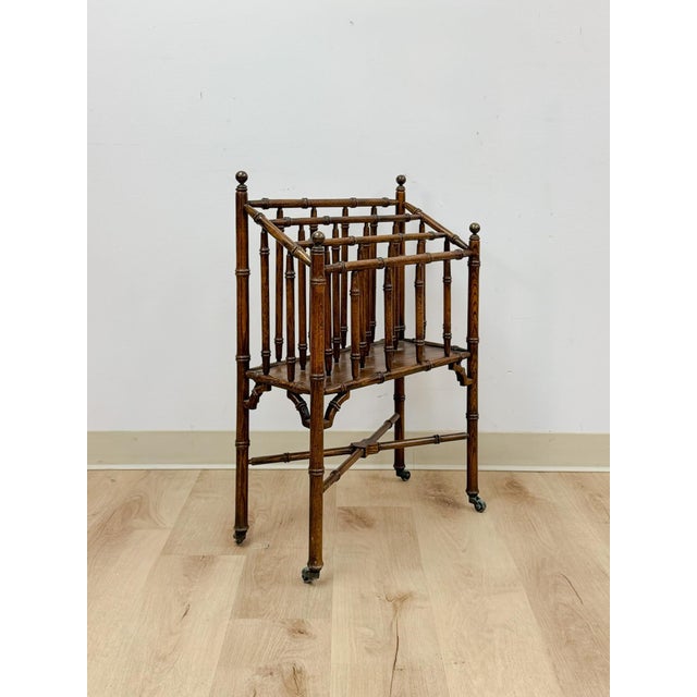 This rare vintage English Canterbury faux bamboo magazine rack on wheels is a beautifully crafted and genuinely...