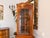 Corner glass display cabinet in colonial style. Dimensions: Height x Width x Depth 187 cm x Leg 46 cm. For sale is a...