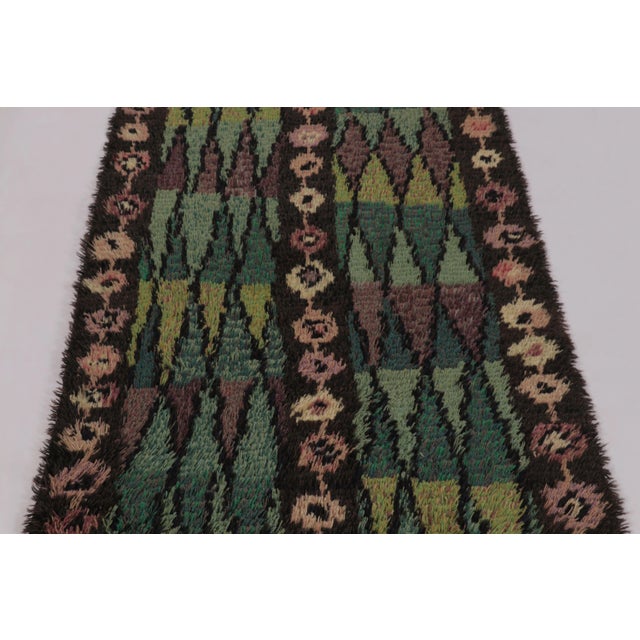 Hand-knotted in lush, high-pile wool in Sweden circa 1960-1970, this 3x5 vintage Swedish Rya rug is a bold new addition to...