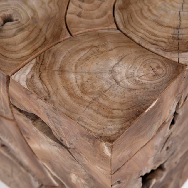 Organic modern side table crafted from natural teak root fragments placed together in a minimalist block design. Each...