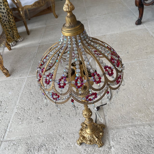Antique Gilt Brass and Glass Beaded Lamp Late 19th-early 20th century, Europe An antique gilt brass and bronze lamp with...