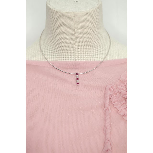 18K white gold ruby and diamond pendant necklace by the renowned Japanese jeweler MIKIMOTO, this elegant necklace features...