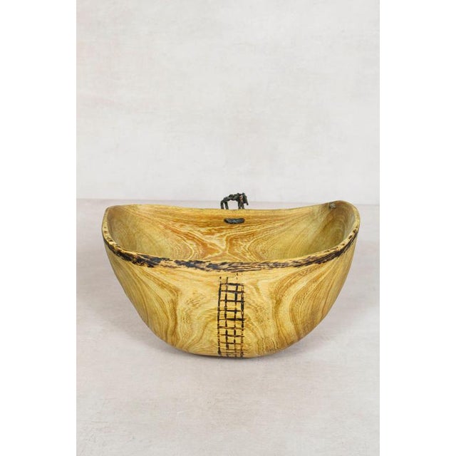 This hand-carved wooden bowl is made by the Turkana, a nomadic community in north-west Kenya prized for their woodcarving...