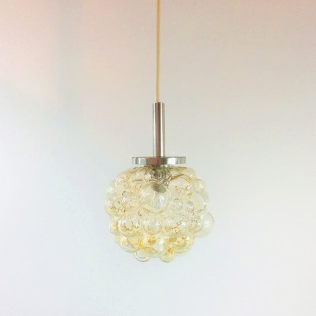 Mid-century modern pendant/ceiling light designed by helena tynell for limburg (germany, 1960s). The light amber/champagne...