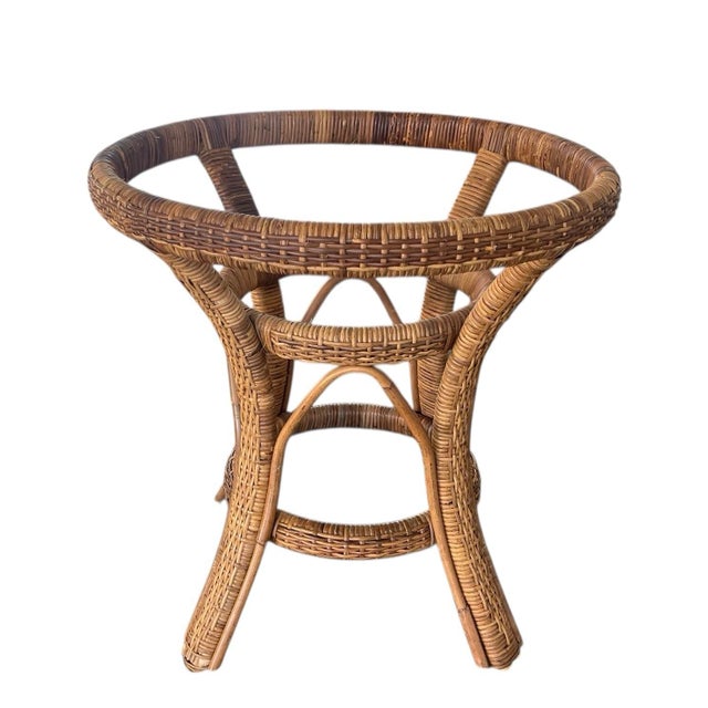 This vintage dining table base is crafted in woven rattan peel over natural rattan framework, showcasing a warm honey-...