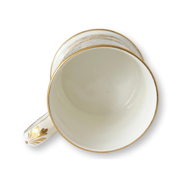 This stunning Victorian porcelain presentation mug features intricate gilded inscriptions, commemorating Emily Warburton's...