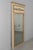 An early 20th century French Louis XVI style trumeau mirror with painted pine frame and gilded trim. Carved giltwood...