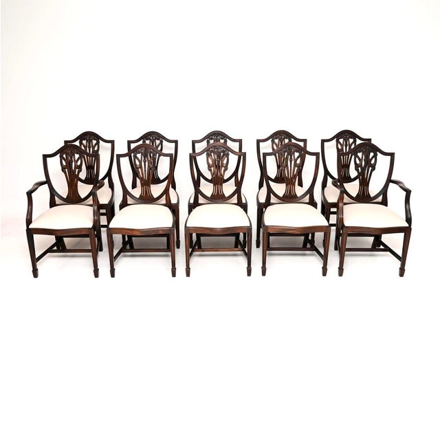 A lovely set of ten antique shield back dining chairs in the Sheraton style. They were made in England, and date from...