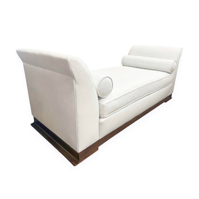 An angelic compact daybed upholstered in a crisp (high-quality) white vinyl, featuring a long loose seat cushion, two...
