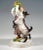 Very rare meissen art nouveau porcelain group: girl in a striped dress with polka dots and a white blouse holding a...
