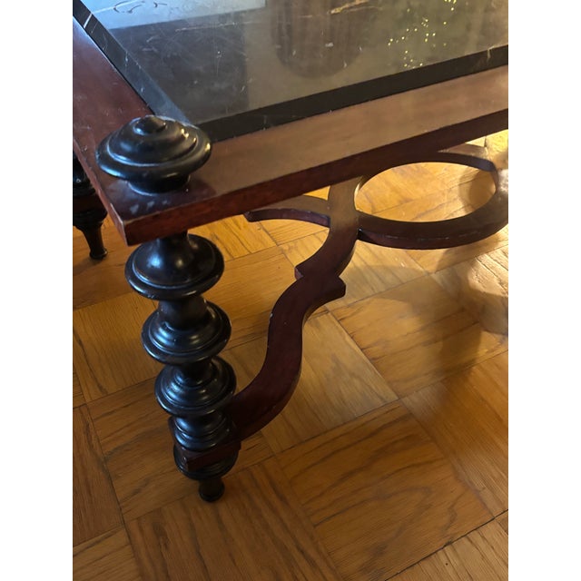 This baroque style coffee or cocktail table with distinctive black marble top. Marble top is inset and a removable slab....