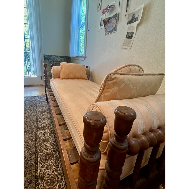 A classic antique 'Jenny Lind' style Spool/Spindle Daybed with trundle. Custom Upholstered in the 1980's. The solid wood...