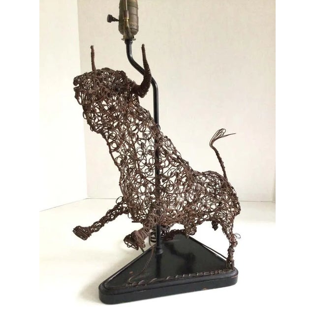 1950s Table Lamp of Abstract Twisted Wire Sculpture of a Bull on Wood Base Height to top of finial: 27" Height to top of...