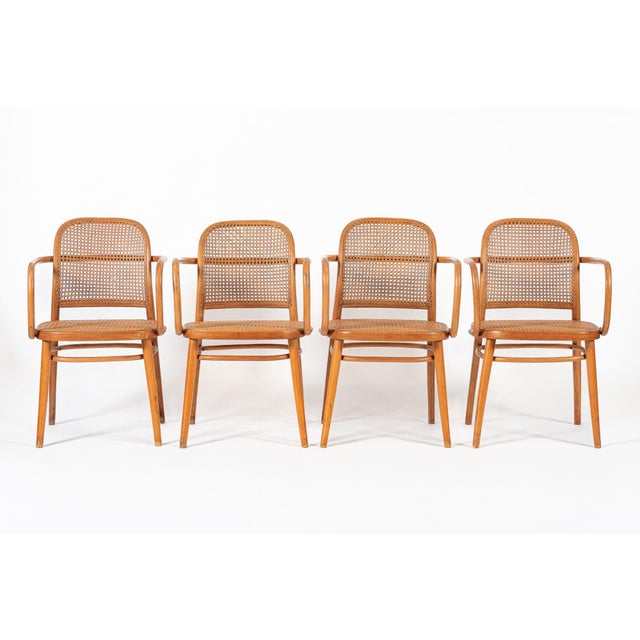 This set of four vintage mid century Bentwood Prague Model 811 cafe dining chairs were made in Czechoslovakia by Ligna...
