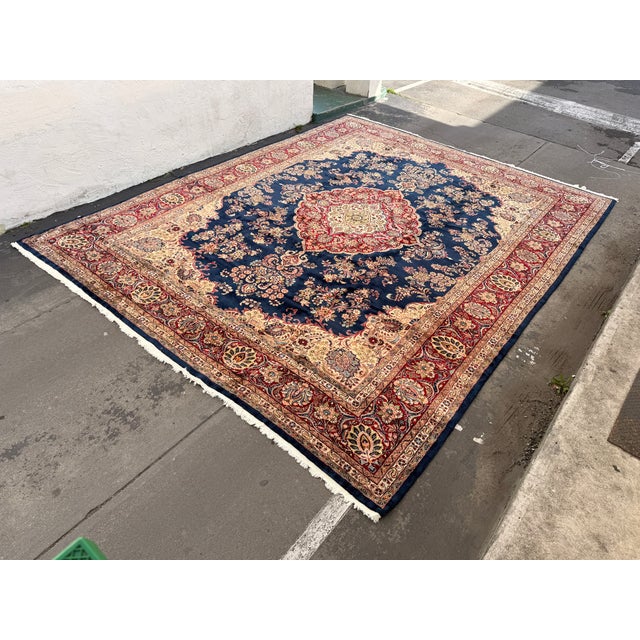 Design Plus Gallery presents an 11ft 10in × 15ft 4in Sarouk Area Rug. The rug displays a traditional medallion layout...