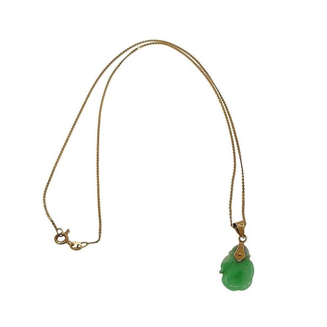 Estate Carved Jade Pendant Necklace. This estate jade necklace is crafted in 14 karat yellow gold and features a carved...