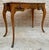 Elegant French writing table crafted in walnut, designed in the Louis XV style. The table features a shaped rectangular...