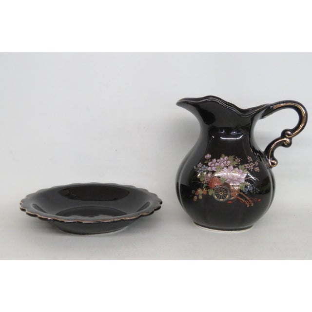 This charming Pitcher and Underplate 2pc Set is made of ceramic. This gorgeous set features a bold black base color with...