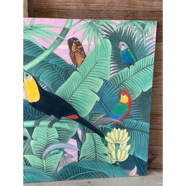 A fabulous vintage tropical painting on cloth featuring a vibrant jungle scene with toucans, parrots, butterflies, and...