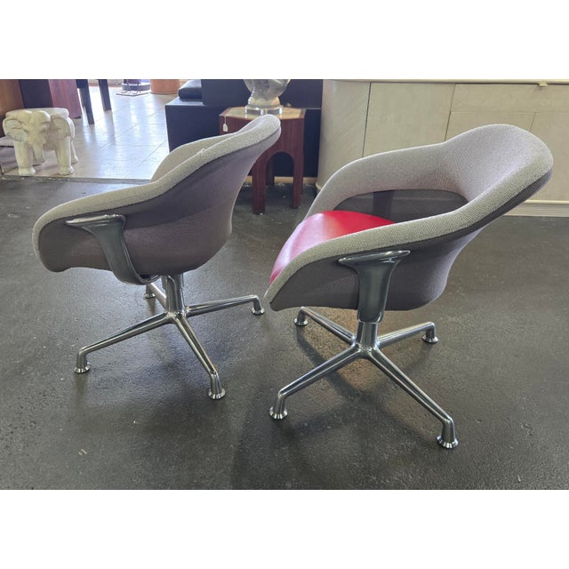 Great pair of swivel lounge chairs feature a Chrome frame with red vinyl seats, grey upholstery and mesh sides. Our...
