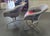 Great pair of swivel lounge chairs feature a Chrome frame with red vinyl seats, grey upholstery and mesh sides. Our...