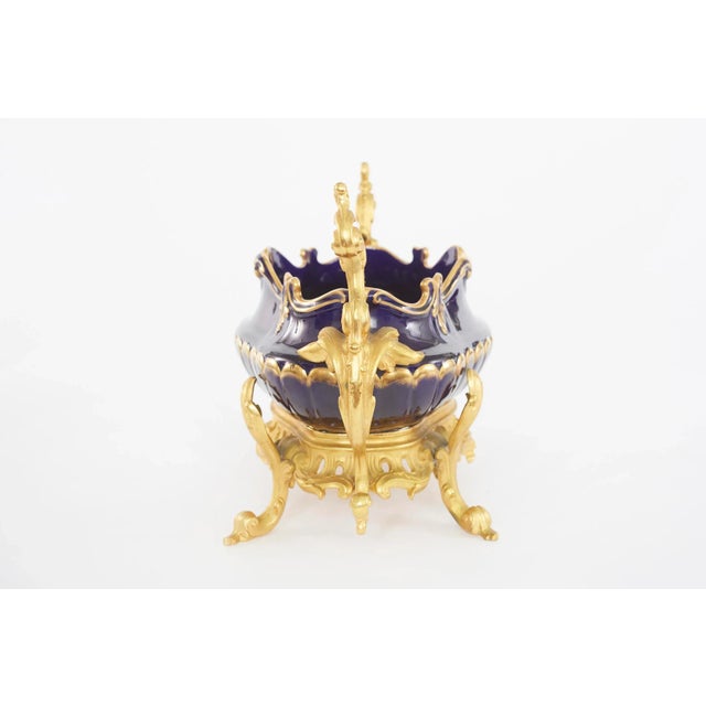 19th Century hand painted gilt gold design porcelain with footed bronze mounted decorative centerpiece with side handles....