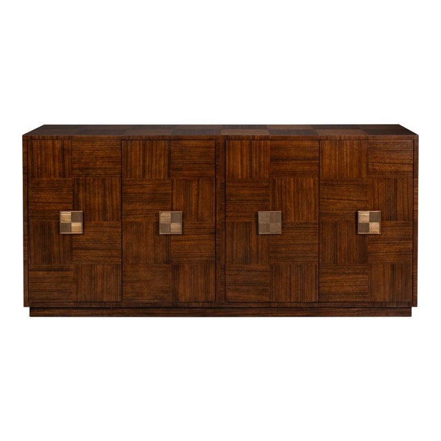 Alternating wood grain supplies the decoration across the broad case. Block parquetry runs across all four doors and...
